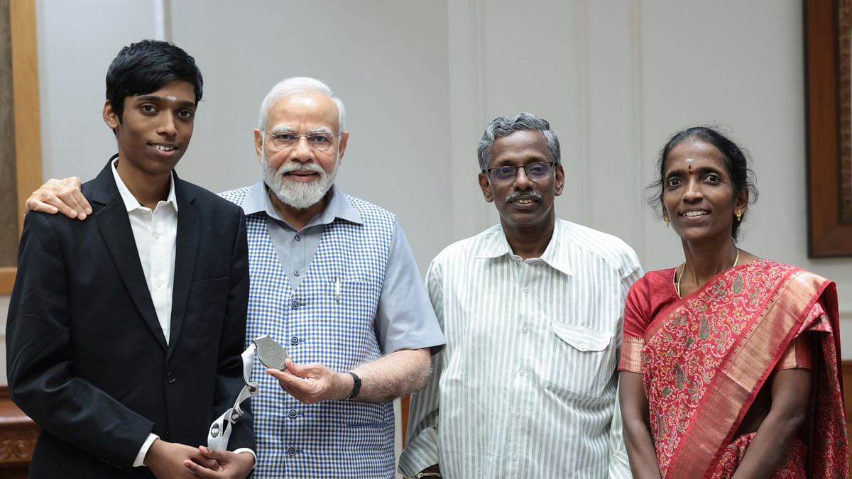 Prime Minister Narendra Modi with R Praggnanandhaa and his family.