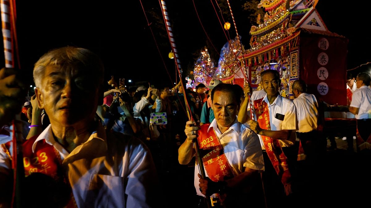 Pilgrims take part in the Hungry Ghost Festival, in Keelung, Taiwan. 