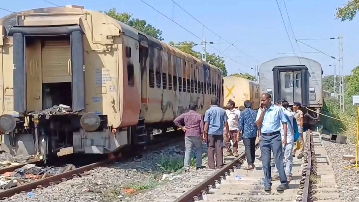 Police personnel stand guard at the site of train fire accident where forensic experts are conducting an investigation for the second day, in Madurai, Sunday, Aug 27, 2023.