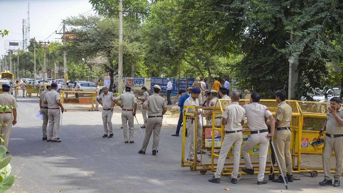 Police personnel stand guard ahead of a rally of Hindu organisations to be taken out in Nuh, weeks after violence in the region, in Gurugram. 