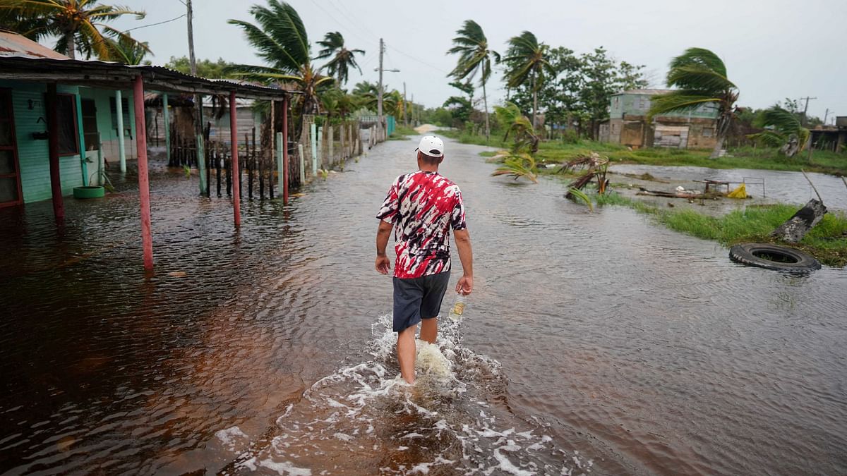 School teacher Roy Ross, 49, walks in a flooded road after the passage of Storm Idalia in Playa Majana, Cuba.