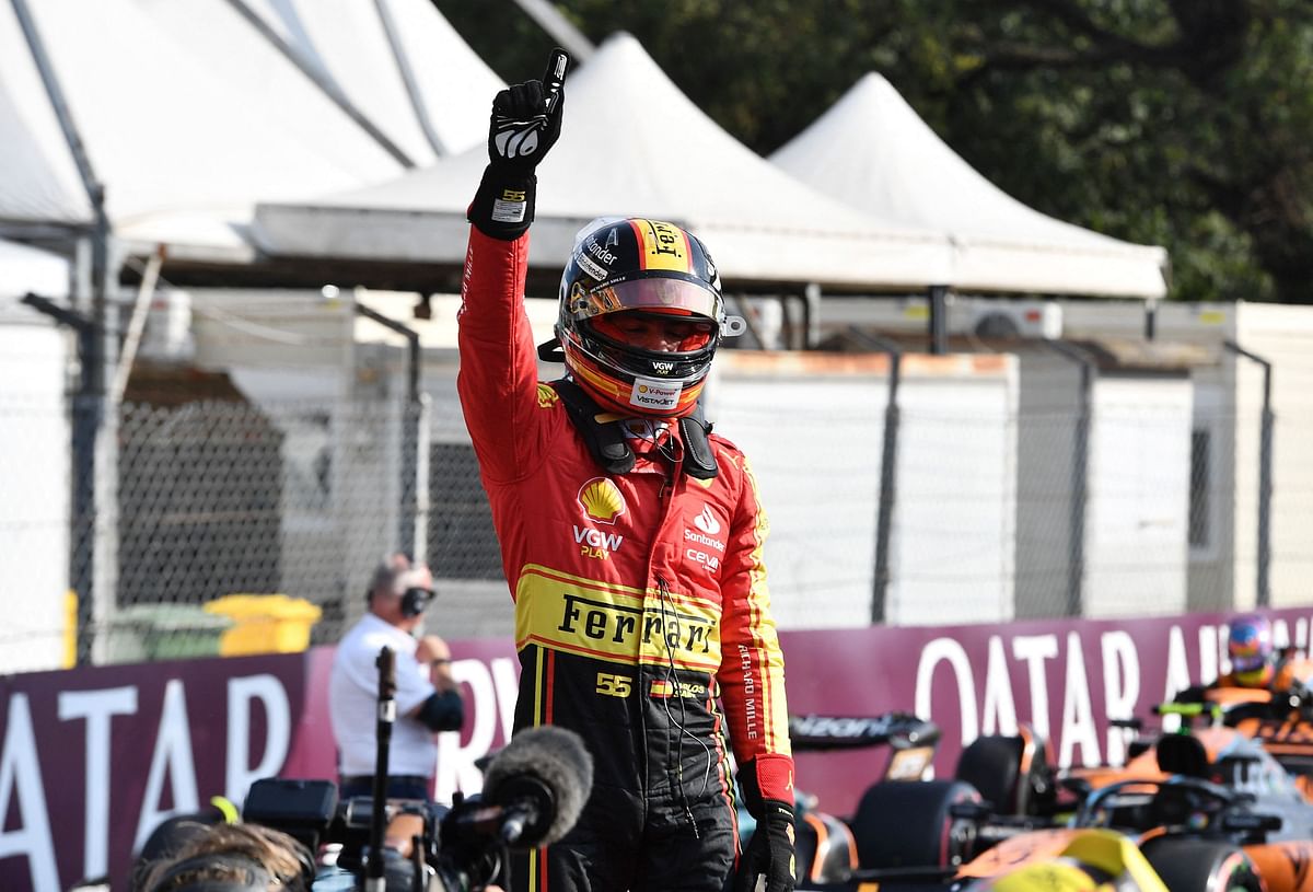  Ferrari's Carlos Sainz Jr. celebrates after qualifying in pole position.