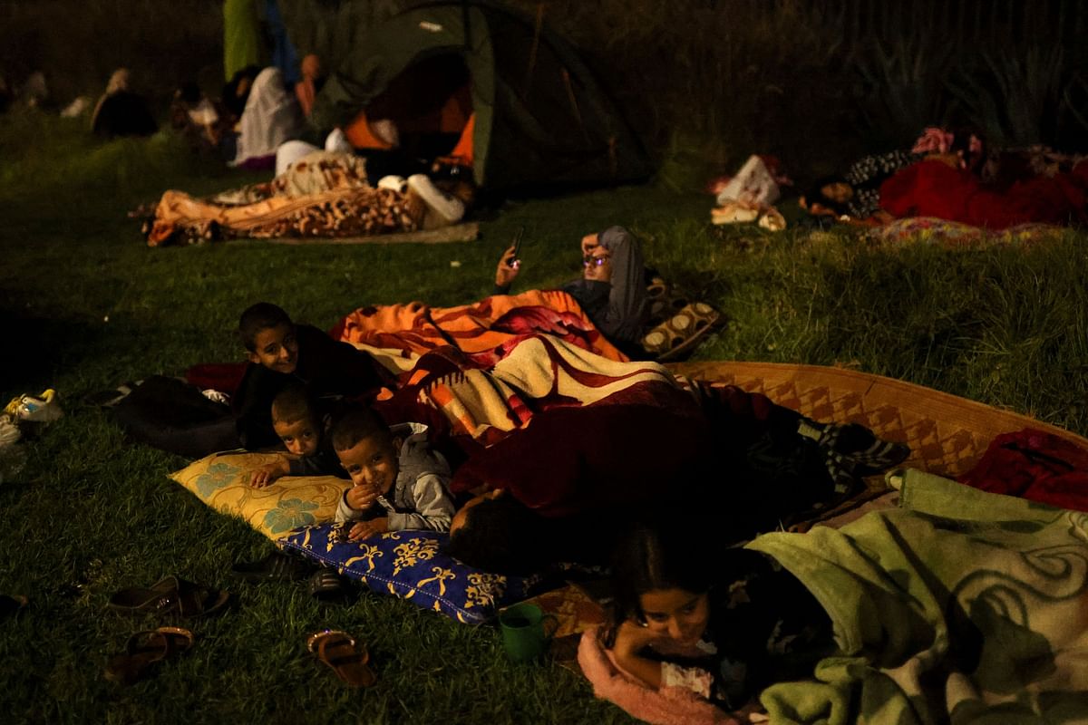 Residents rest along Avenue de la Menara, following a powerful earthquake in Marrakesh, Morroco.