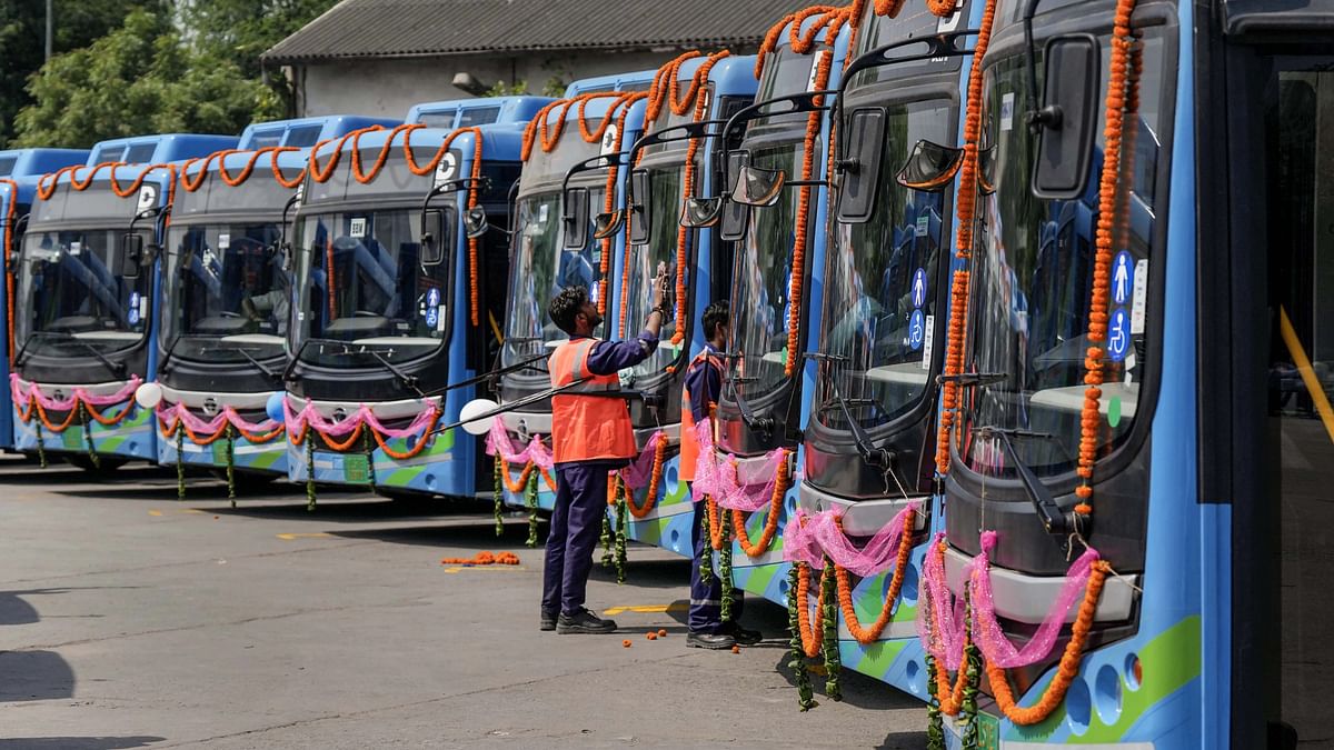 A worker cleans electric buses during their flag-off ceremony, at IP Depot in New Delhi. 400 new e-buses are expeted to be launched at the event.