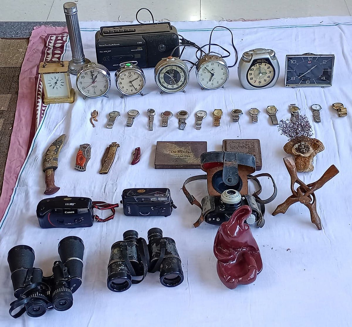 Miscellaneous items in the collection including binoculars and clocks.