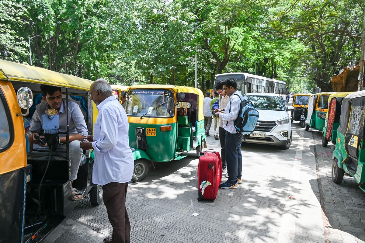Passengers haggle with a few available auto-rickshaw drivers in Malleswaram on Tuesday. 