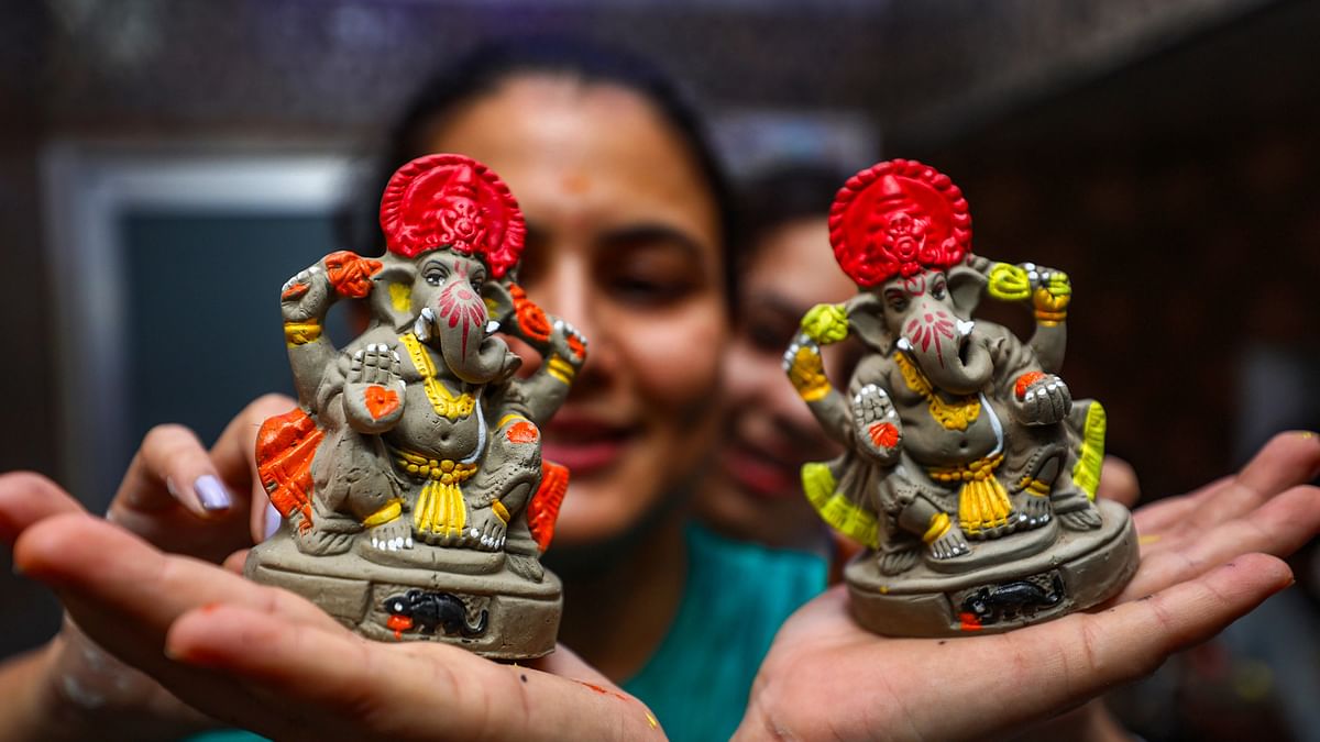 Disha volunteers show clay idols of Lord Ganesha ahead of the Ganesh Chaturthi festival, in Jammu.