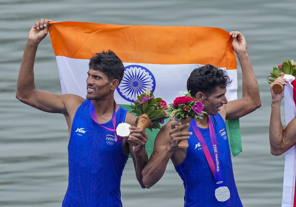 India’s Arjun Lal Jat and Arvind Singh wave Indian tricolours as they stand at the podium after winning silver medal in Men’s Light-weight Double Sculls at the 19th Asian Games in Hangzhou China Sunday Sept. 24 2023. 