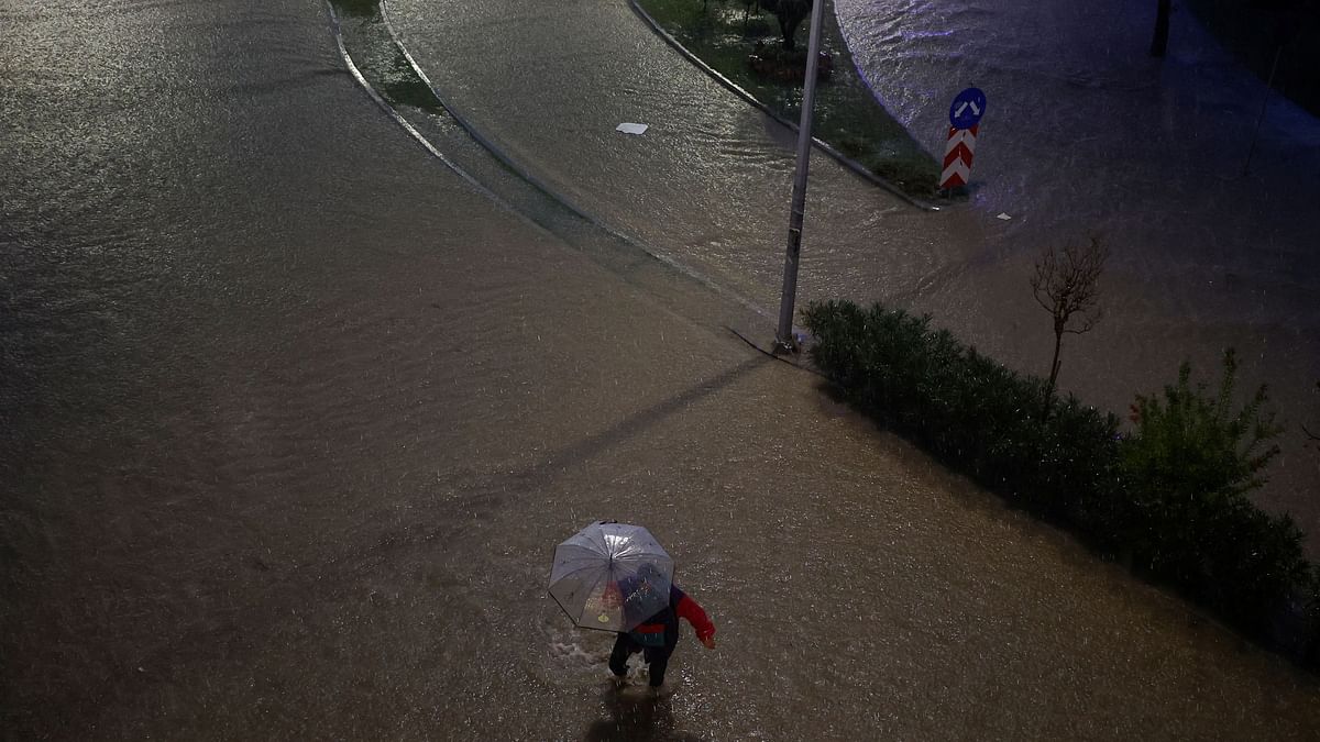 A man tries to make his way in the flooded city of Volos as storm Elias hits the area, in Volos, Greece, September 27, 2023.