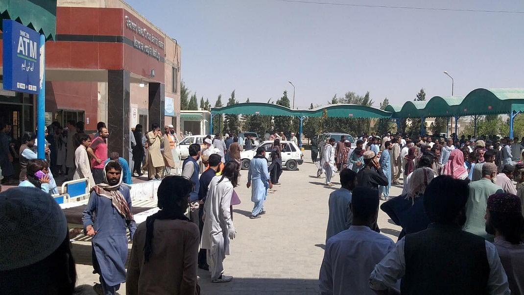 People gather outside the Mastung hospital, following a deadly suicide attack on a religious gathering in Balochistan province, Pakistan.