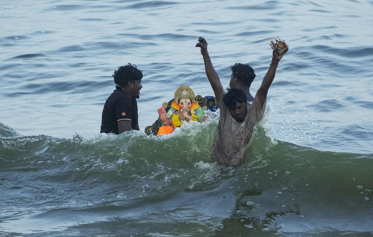 Volunteers immerse an idol of Ganesh for immersion in the Arabian Sea during the fifth day of the Ganesh Chaturthi festival, in Chennai.