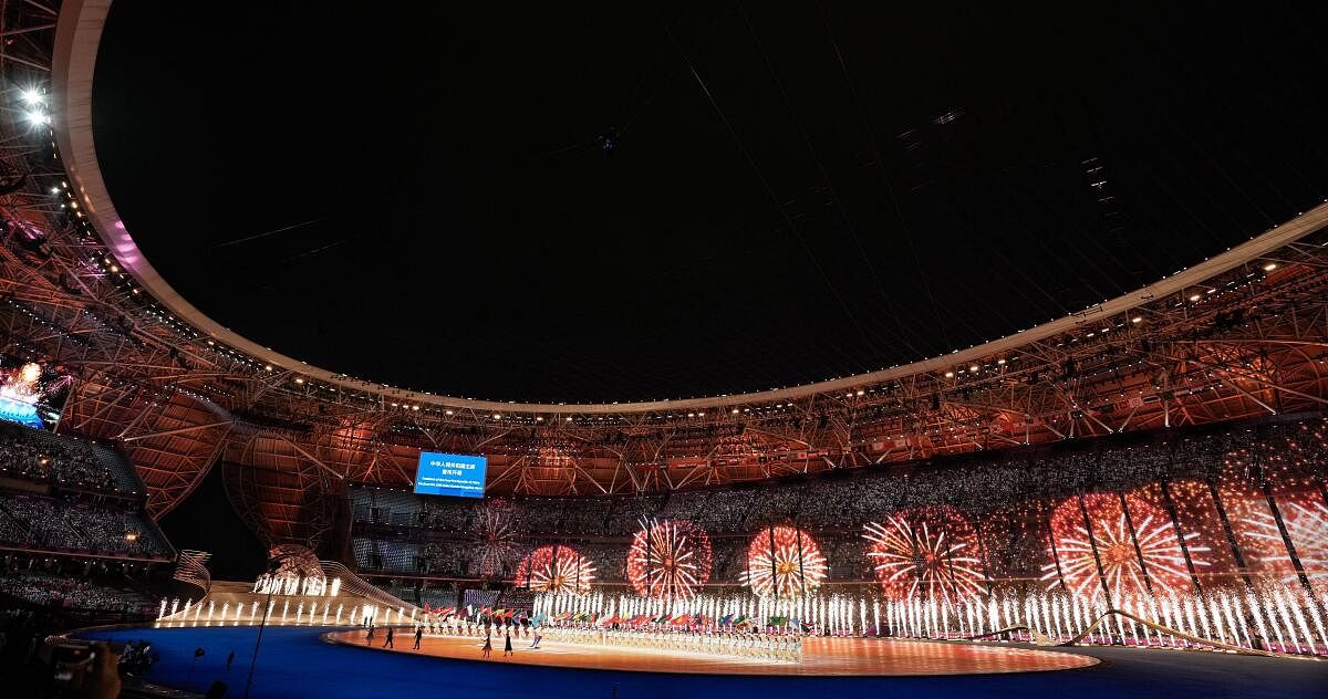 Artists holding national flags of the participating nations perform during the opening ceremony of the 19th Asian Games at the Hangzhou Olympic Sports Centre Stadium.