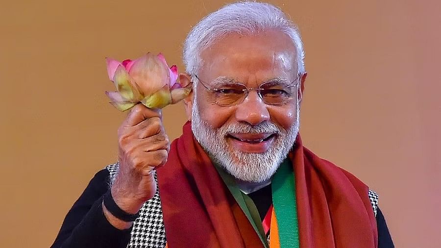 PM Modi holds a lotus in his hand. 