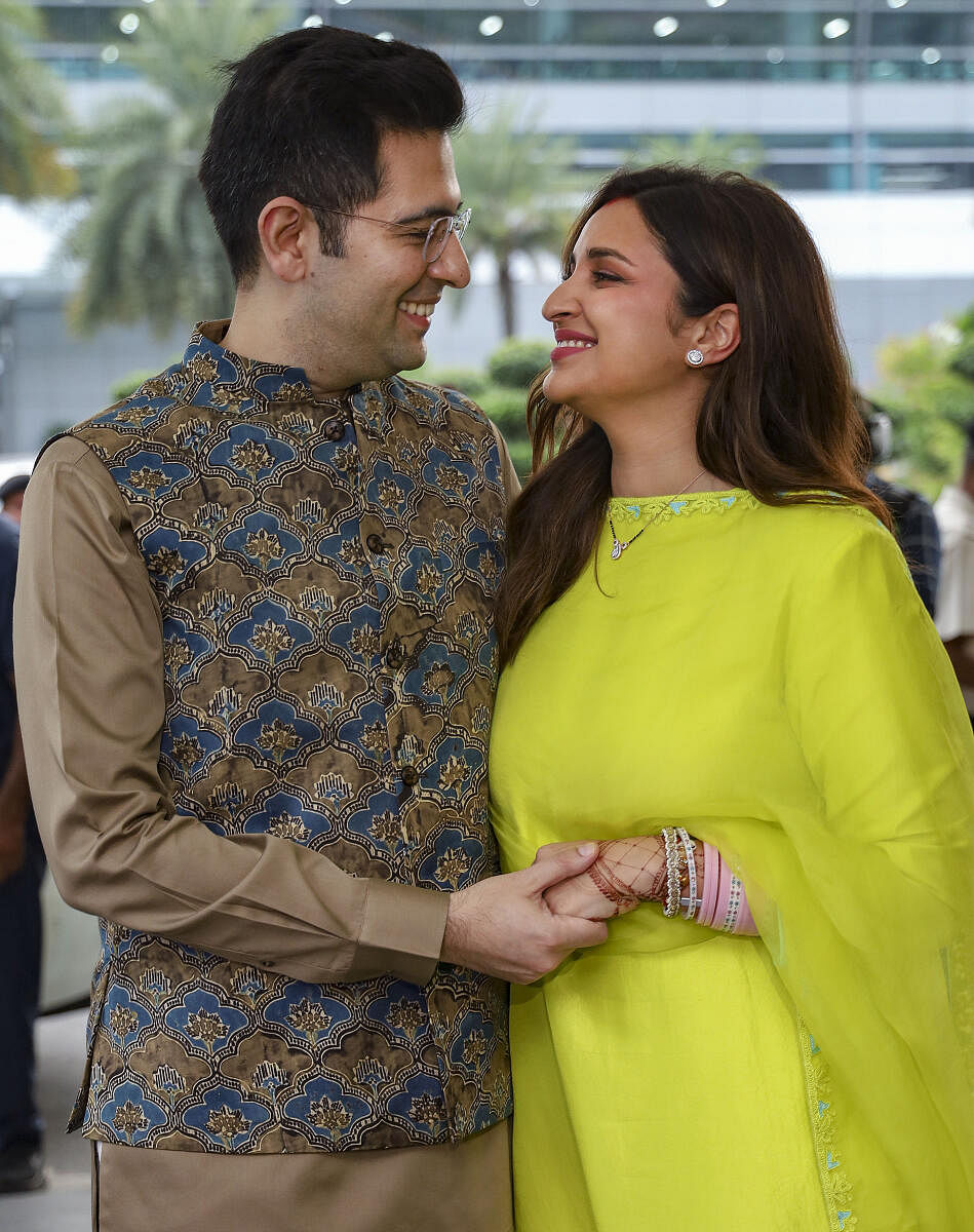 Newly-wed actor Parineeti Chopra and AAP MP Raghav Chadha pose for photographs upon their arrival in New Delhi.