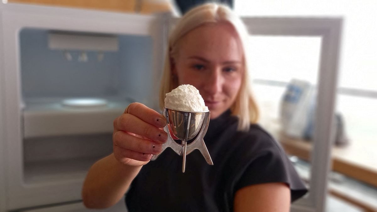 A view shows the world's first vanilla ice cream made with plastic waste, held up for the camera by its maker, artist and designer Eleanora Ortolani at Central Saint Martins in London.