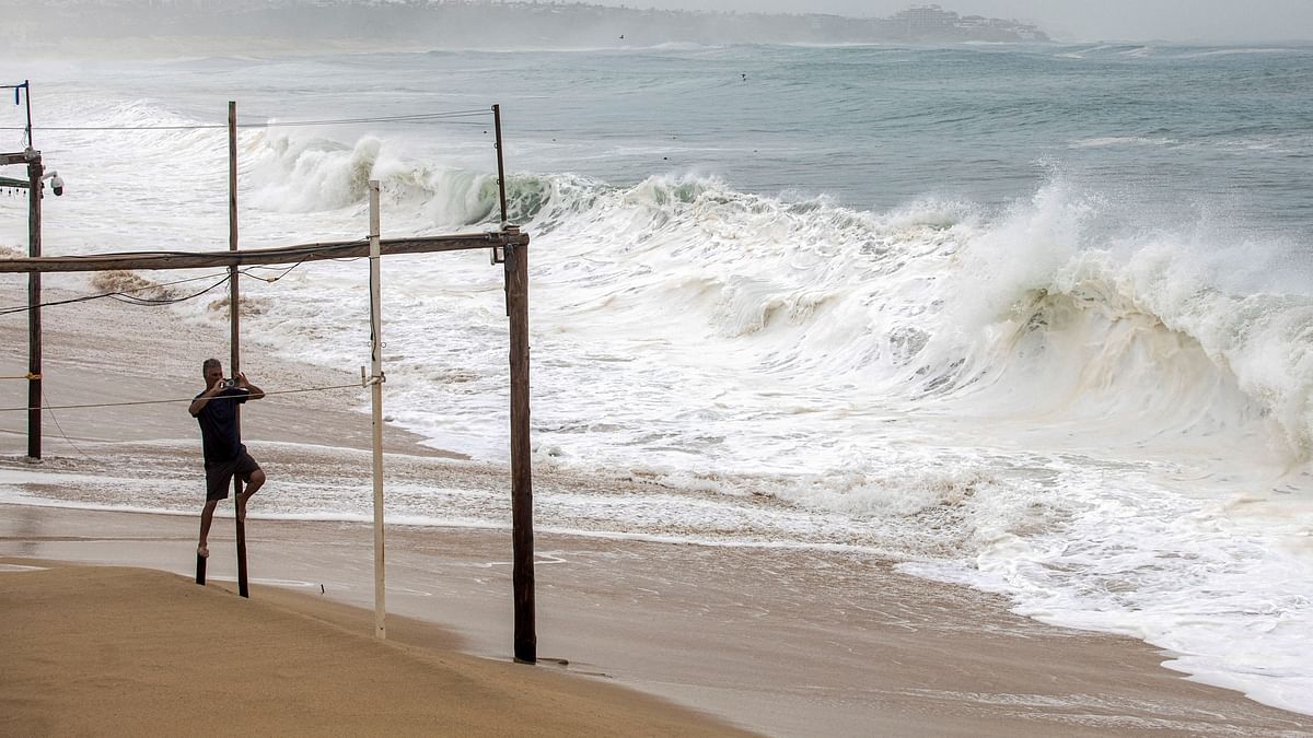 A tourist films with his phone on a beach as Hurricane Norma barrels towards the Baja California peninsula, in Cabo San Lucas, Mexico. 