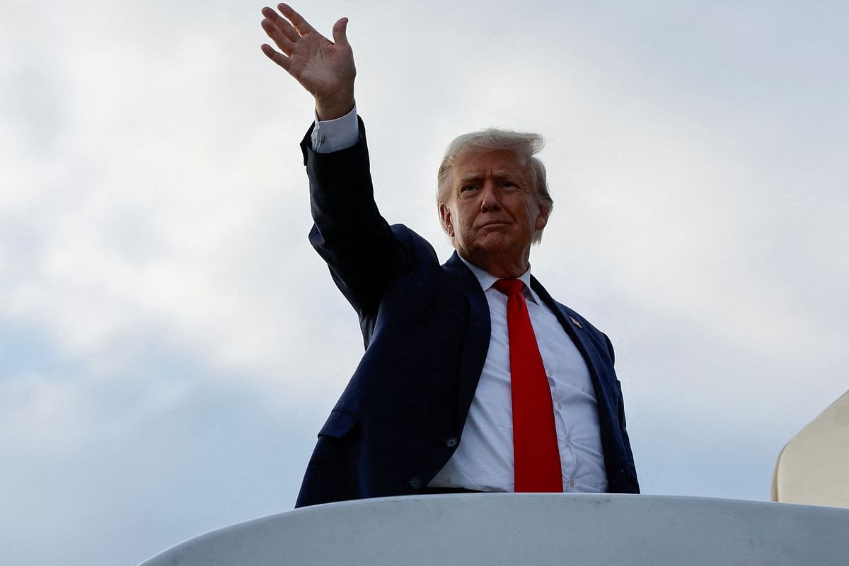 Former U.S. President and Republican presidential candidate Donald Trump waves as he boards his plane to depart from Eastern Iowa Airport after campaigning in Cedar Rapids, Iowa.