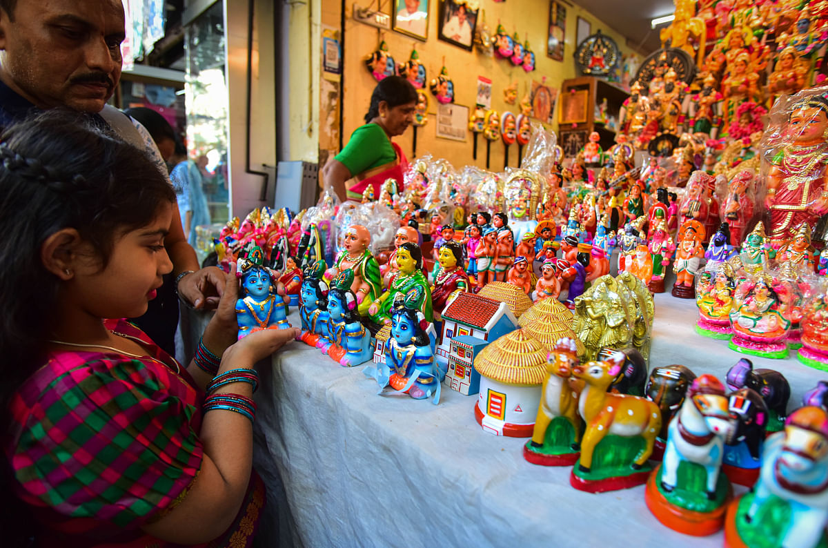 A little girl shopping for dolls in Malleswaram. 