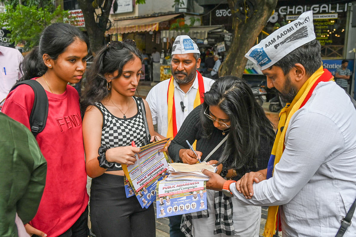 AAP workers interact with citizens as part of an awareness campaign on Church Street on Monday. 