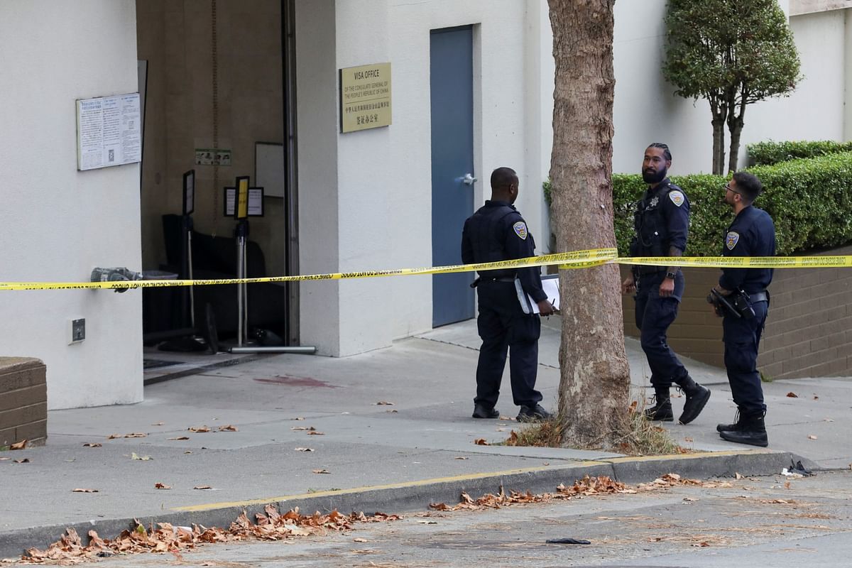 Law enforcement members stand on the street near the Chinese consulate, where local media has reported a vehicle may have crashed into the building, in San Francisco.