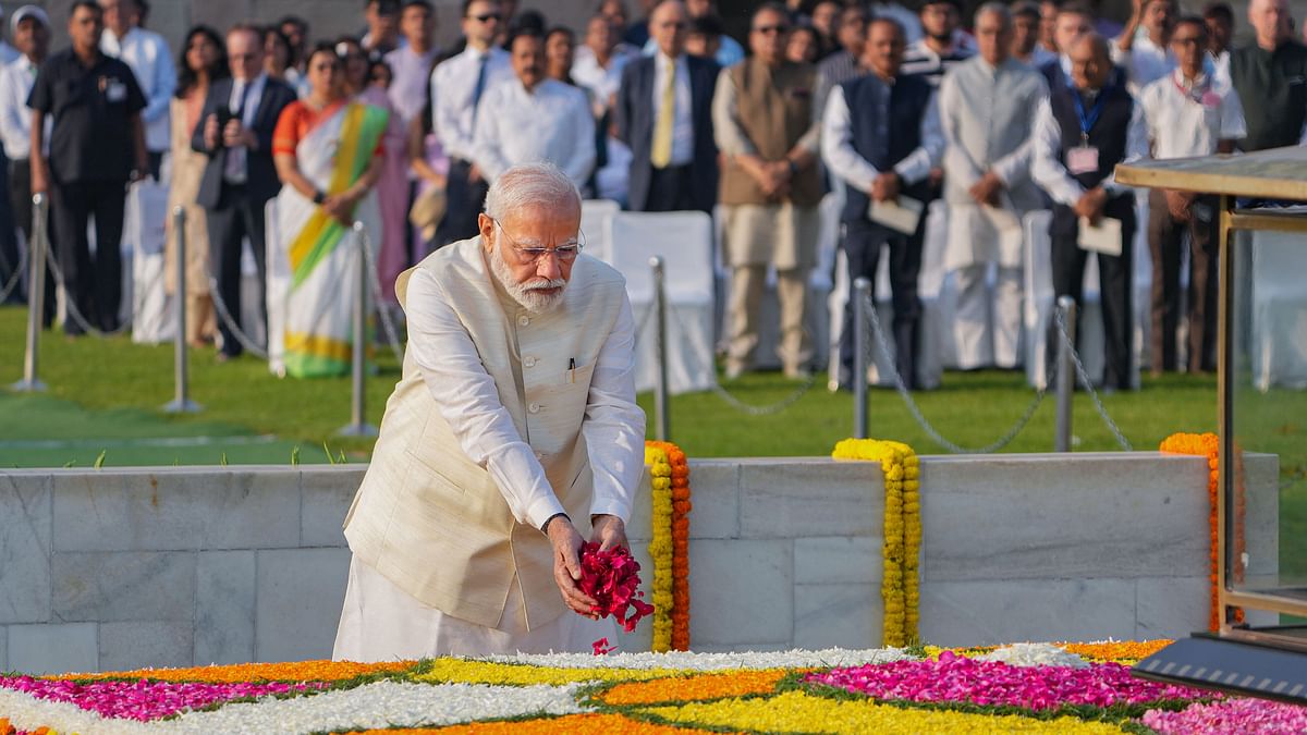 Prime Minister Narendra Modi pays floral tributes to Mahatma Gandhi on the occasion of his birth anniversary, at Rajghat in New Delhi.