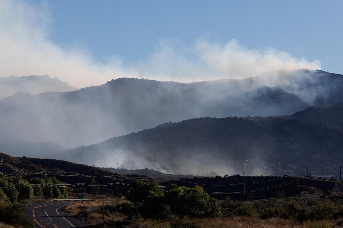 The Highland Fire, a wind- driven wildfire burns in the hills near Aguanga, California.