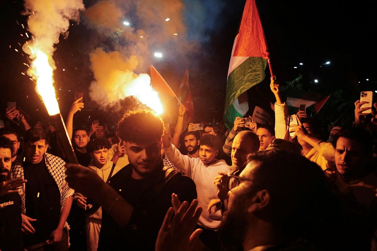 Demonstrators shout slogans as they light flares during a rally in solidarity with Palestinians in Gaza, in Istanbul, Turkey.