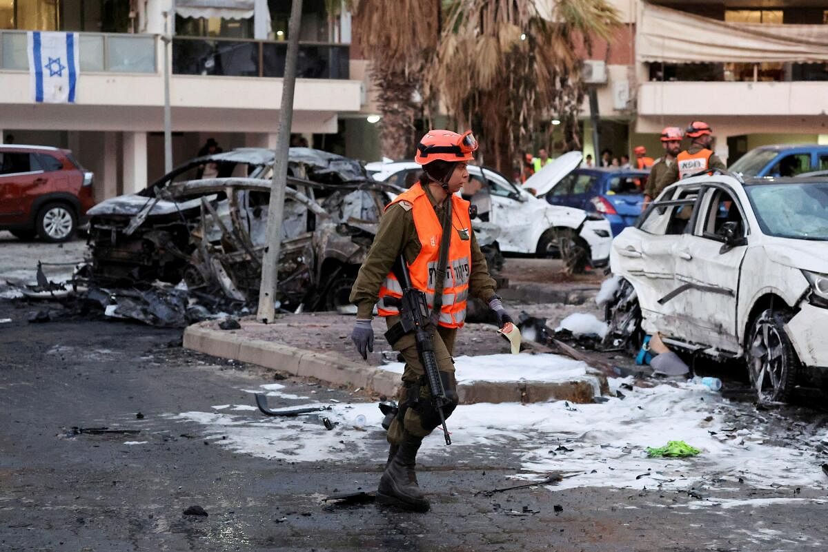 An emergency worker inspects damage caused by rockets fired from Gaza that struck a residential area in Ashdod.