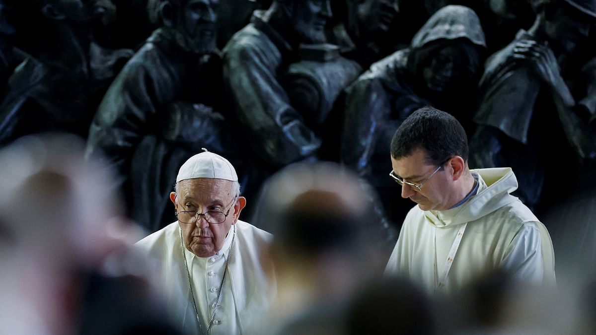 Pope Francis holds prayer for migrants and refugees, with the 'Angels Unaware' monument, dedicated to the world's migrants and refugees, behind him in St. Peter's Square, at the Vatican. 