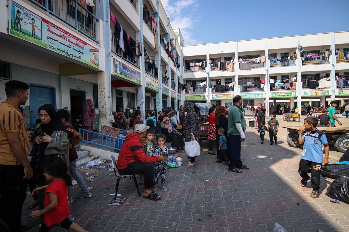 Displaced Palestinians shelter in the courtyard of a school operated by the UNRWA west of Khan Younis, southern Gaza Strip, on October 11.