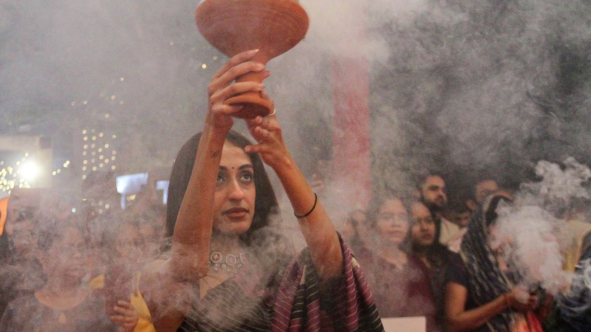 A devotee performs ‘Dhunuchi’ dance on Saptami during Durga Puja festival, in Gurugram, Saturday, Oct. 21, 2023.