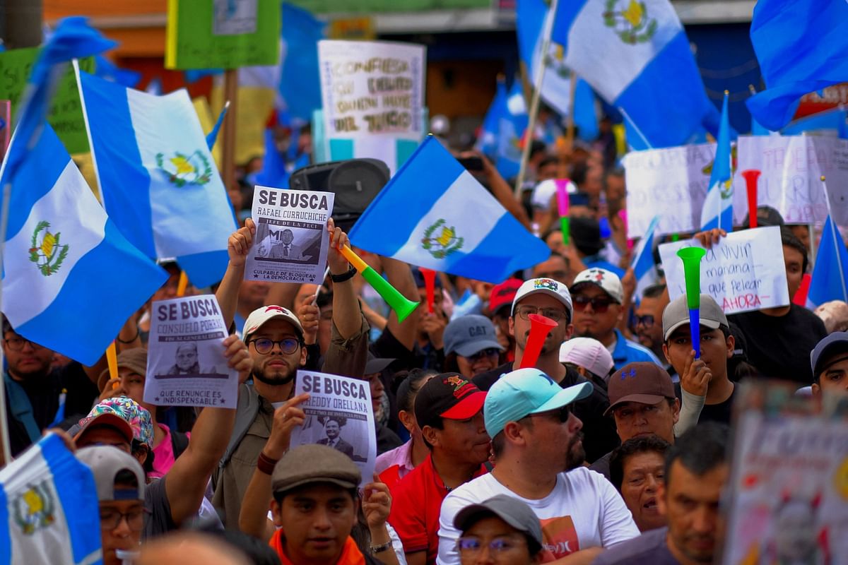 People take part in a protest to demand the resignation of powerful senior prosecutors accused of working to undermine President-elect Bernardo Arevalo's ability to take office, in Guatemala City, Guatemala.