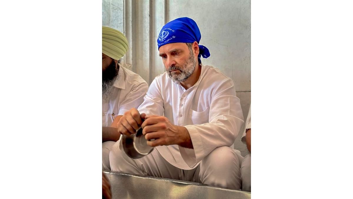Congress leader Rahul Gandhi performs 'sewa' during a visit at the Golden Temple, in Amritsar.