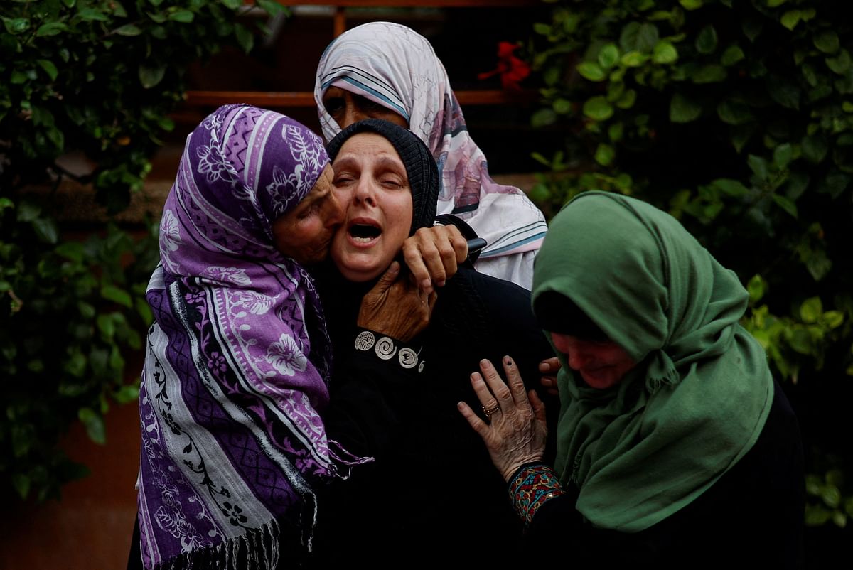 Palestinians mourn during the funeral of Palestinian nurse Haniyeh Qudih, who was killed in an Israeli strike, as the conflict between Israel and Palestinian Islamist group Hamas continues, in Khan Younis in the southern Gaza Strip, October 27, 2023. 