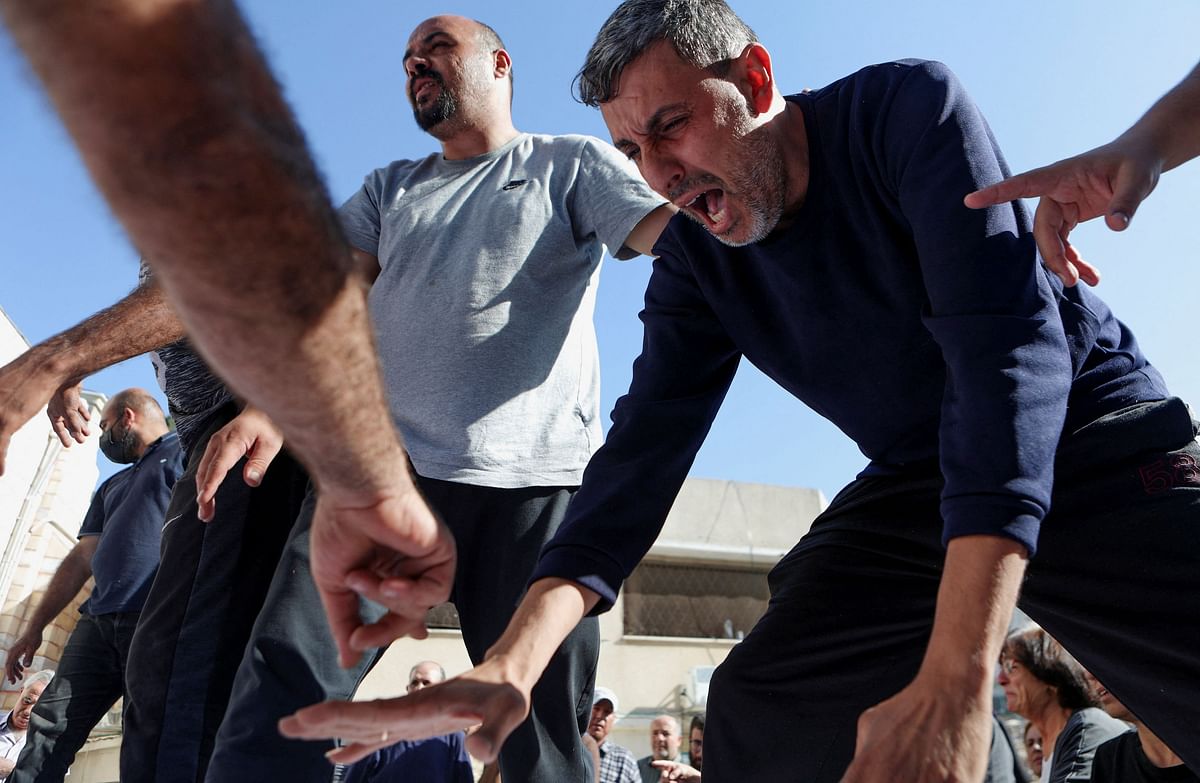 Mourners attend a funeral for Palestinians killed in an Israeli strike that damaged the Greek Orthodox Saint Porphyrius Church, where Palestinians who fled their homes were taking shelter, at the church in Gaza City, October 20, 2023.