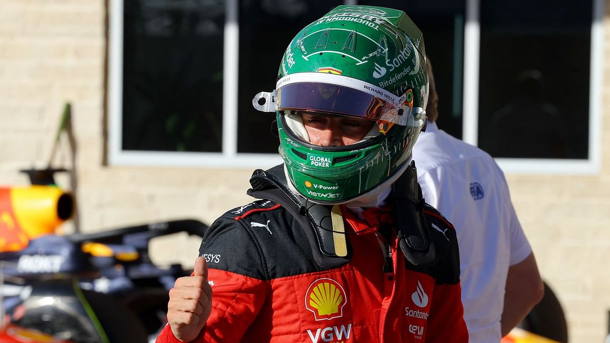 Ferrari's Charles Leclerc celebrates after qualifying in pole position. 