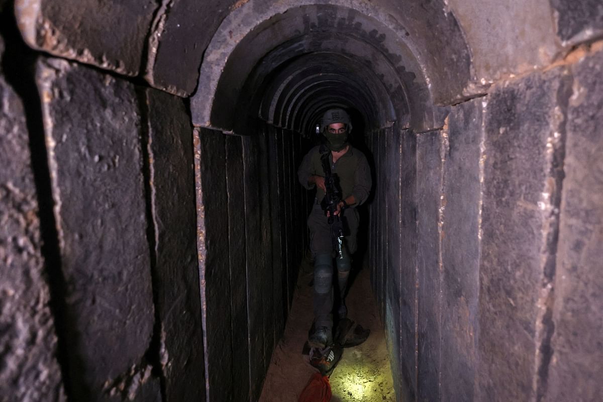An Israeli soldier walks through a tunnel underneath Al Shifa Hospital in Gaza City, amid the ongoing ground operation of the Israeli army against Palestinian Islamist group Hamas, in the northern Gaza Strip, November 22, 2023. 