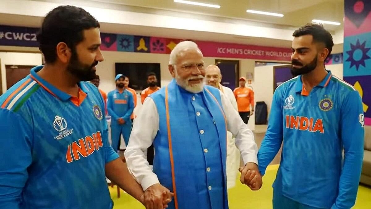Prime Minister Narendra Modi with Indian captain Rohit Sharma and player Virat Kohli during a meeting with the team in the dressing room at the Narendra Modi Stadium during the ICC Men’s Cricket World Cup 2023 final match between India and Australia, in Ahmedabad, Sunday, Nov. 19, 2023. Union Home Minister Amit Shah is also seen.