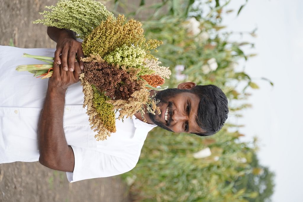Farmer Praveen Hebballi with the various indigenous varieties of jowar. 