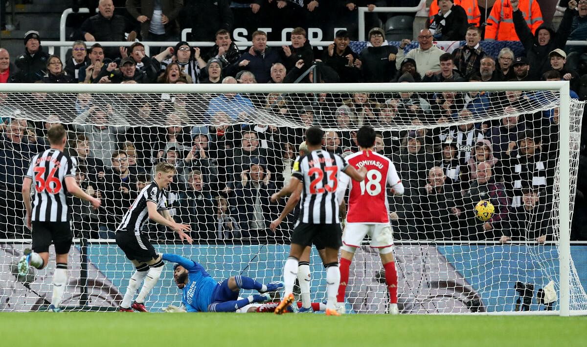 Anthony Gordon scores against Arsenal.