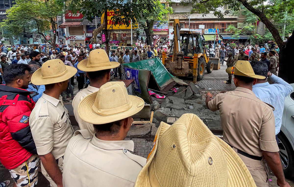 The BBMP on Tuesday demolished many stalls belonging to street vendors at Jayanagar 4th Block shopping complex area. (Right)Maimun Khatoon an artificial jewellery vendor was left to salvage her merchandise from the debris after the BBMP demolished her kiosk. 