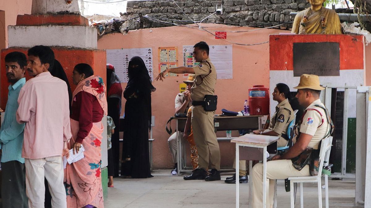 People wait to cast their vote at a polling station during the Telangana Legislative Assembly election in Hyderabad, India, November 30, 2023.