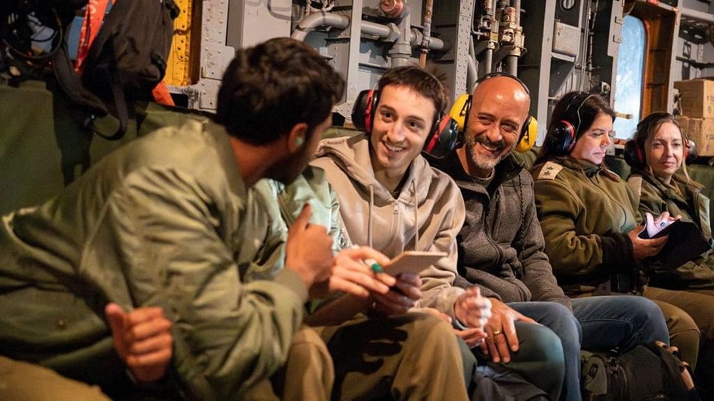 Liam Or, 18, rides with his father in a military helicopter following his release after being held hostage by the Palestinian militant group Hamas in the Gaza Strip, above Israel, in this handout image obtained by Reuters on November 30, 2023. 