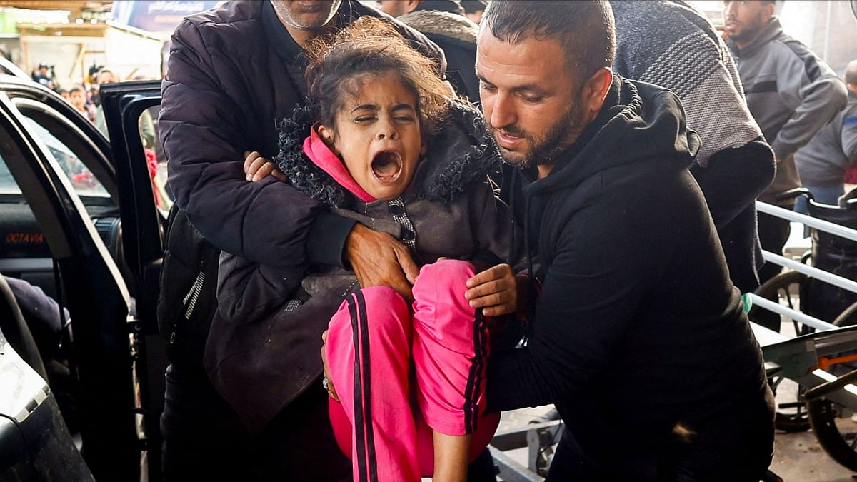 A Palestinian child wounded in an Israeli strike is carried at Nasser hospital, amid the ongoing conflict between Israel and Palestinian Islamist group Hamas, in Khan Younis in the southern Gaza Strip.