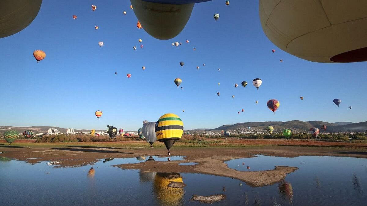 Hot-air balloons fly over Metropolitano park during the International Hot-Air Balloon Festival in Leon, state of Guanajuato, Mexico November 19, 2023. 