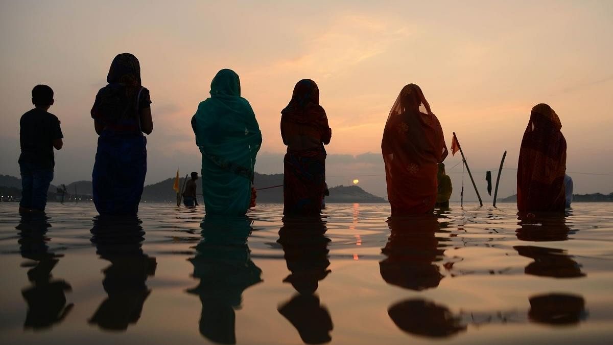 Chhath devotees pay obeisance to rising sun
