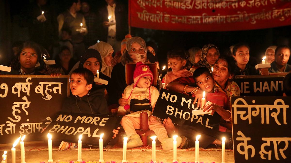 Children with congenital disabilities, believed to be caused by the exposure of their parents to gas leakage during the Union Carbide gas leak disaster in 1984, along with their relatives and supporters take part in a candle light vigil to pay homage to the victims of the tragedy, in Bhopal, Thursday, Nov. 30, 2023.