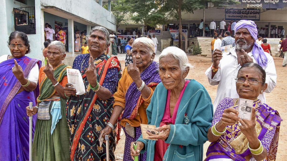 Voters show their fingers marked with indelible ink after casting their votes for the Telangana Assembly elections. 