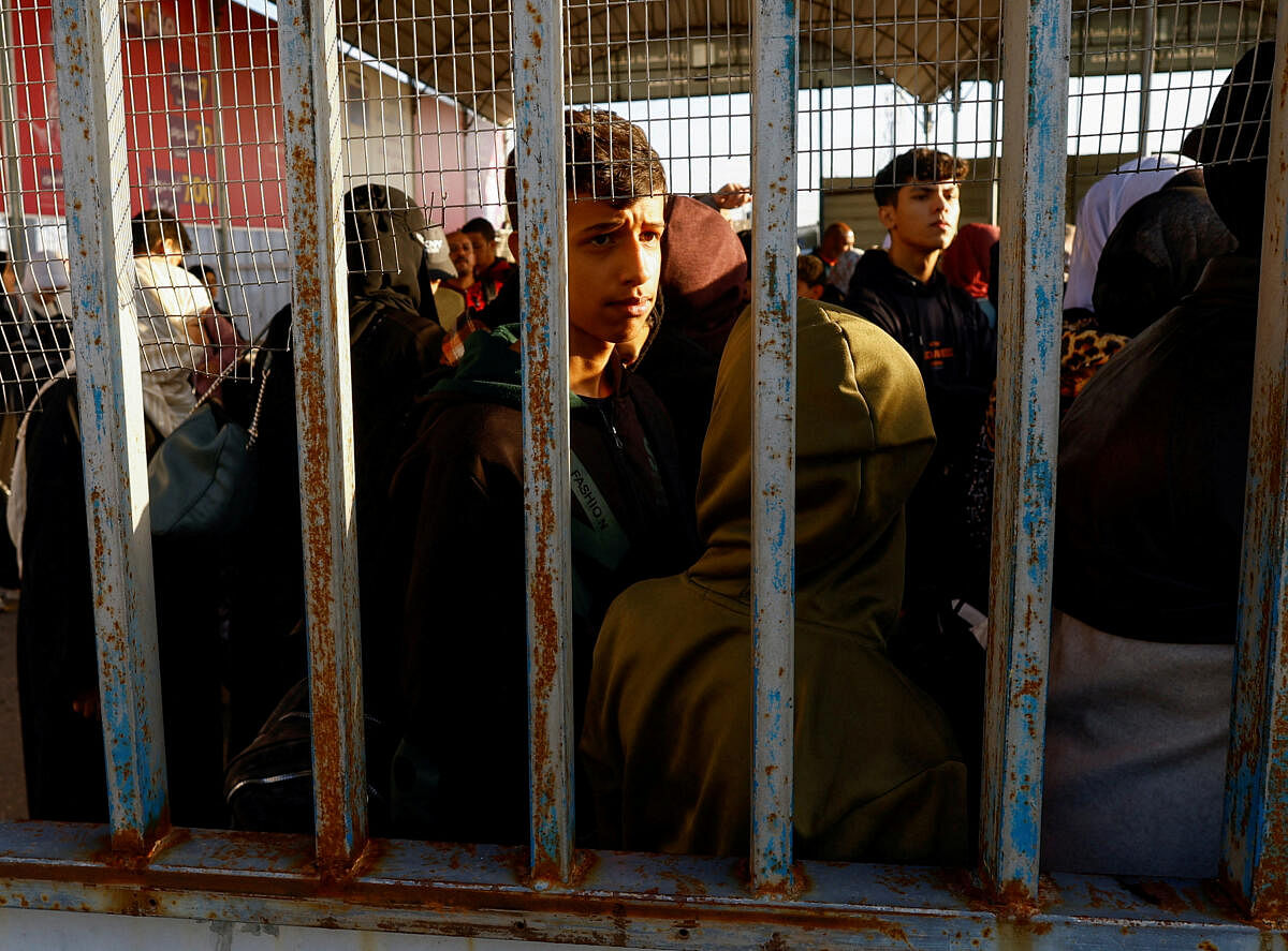Palestinians with foreign passports wait for permission to leave Gaza, amid the ongoing conflict between Israel and Palestinian Islamist group Hamas, at the Rafah border crossing with Egypt.