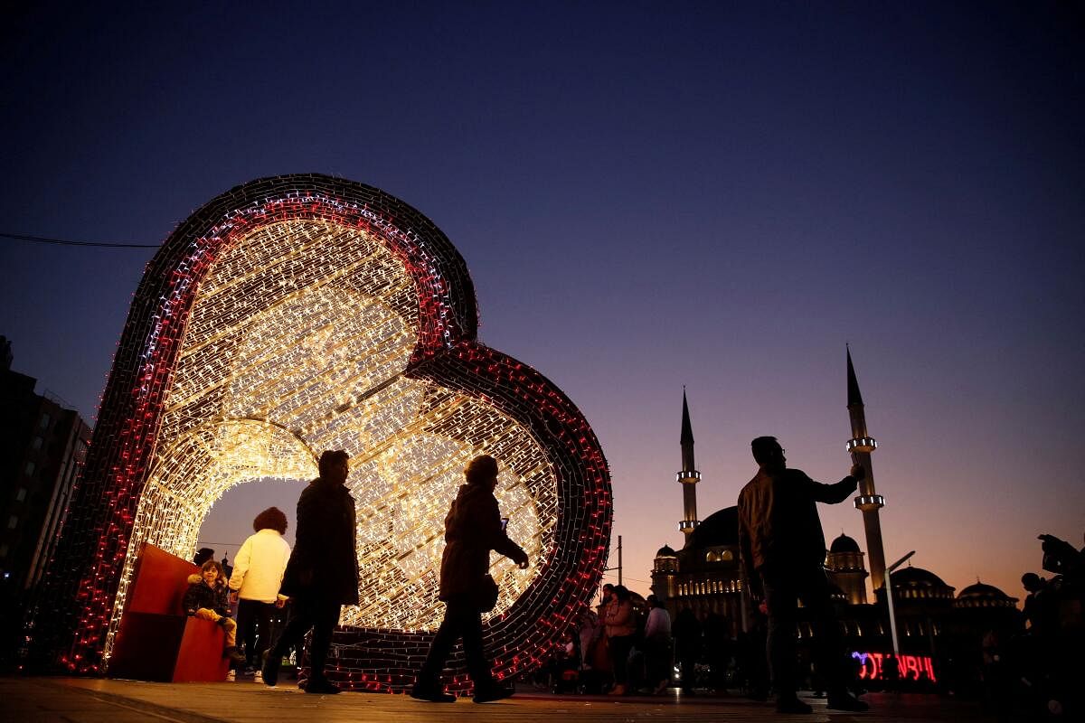 A person takes a selfie with a New Year's Eve decoration at the Taksim Square in central Istanbul, Turkey December 28, 2023. 